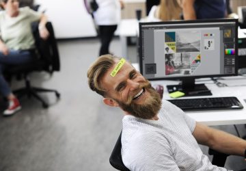 man smiling with sticky note on his head
