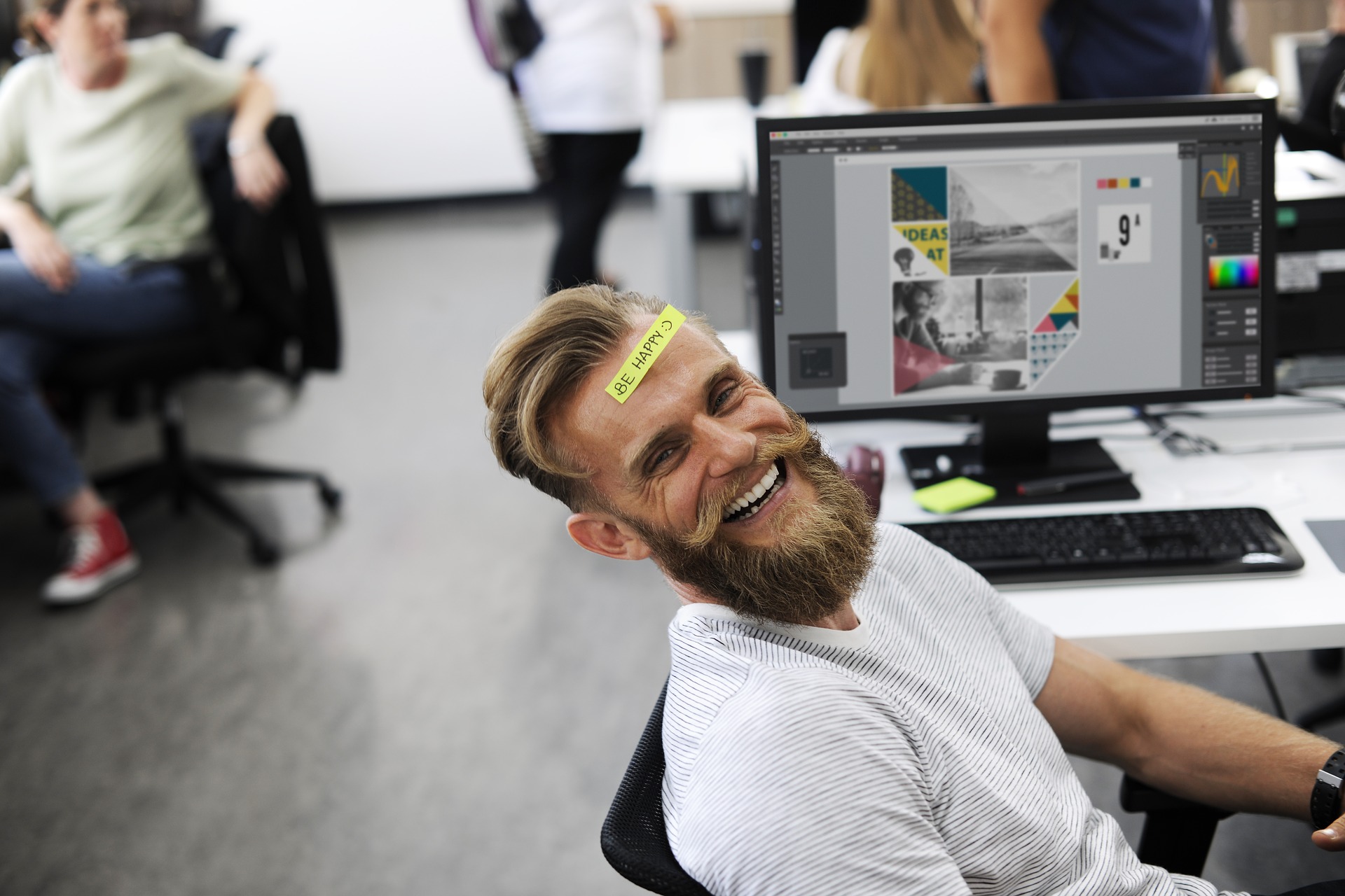man smiling with sticky note on his head