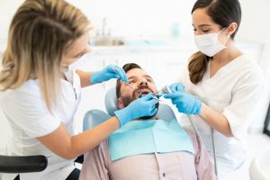 Dentist having dental checkup with patient