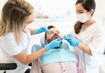Dentist having dental checkup with patient